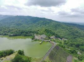 Aerial view of the reservoir between the mountains and forest. photo