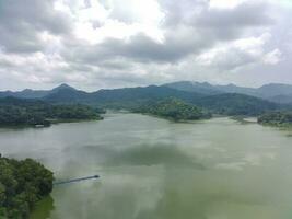Aerial view of the reservoir between the mountains and forest. photo
