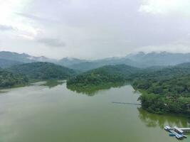 Aerial view of the reservoir between the mountains and forest. photo