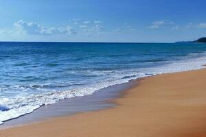 Light blue sea waves and island on clean sandy beach, Tropical white sand beach and soft sunshine background photo