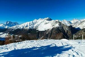 Beautiful sceneric view of Caucasus mountain. The way to mountain with pine forest covered with snow in winter season at Mestia Georgia photo