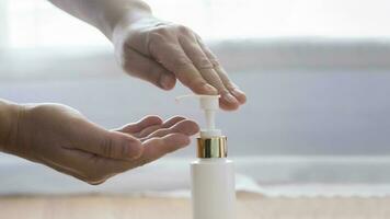 Close up man hands using wash hand sanitizer gel dispenser. photo