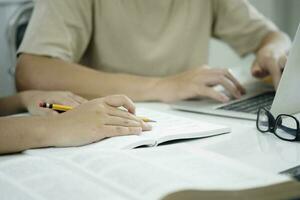 Young students campus helps friend catching up and learning. photo