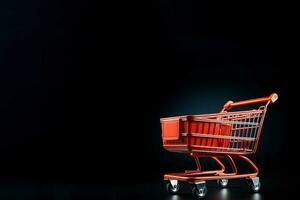 Black background with an isolated shopping cart. photo