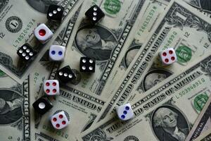 Dollar bills and dice. Financial games. Speculation. photo