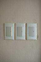 Household light switch on the wall. White plastic switch. photo