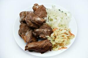 Beautiful fried pieces of pork meat. Pork kebab with vegetables. Meat on a plate. photo