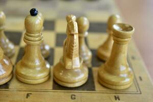 Chess pieces on the board. Wooden chess pieces. photo
