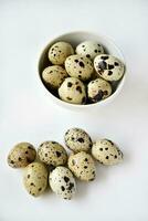 Quail eggs in a white plate. Food eggs on a white background. photo