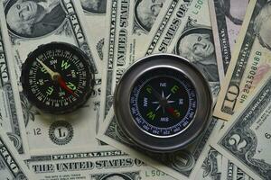 Compass and banknotes. US dollars. Navigation in the financial world. photo