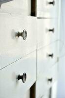 White boxes. Old wooden boxes for documents. Drawers in the nightstand. photo