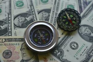 Compass and banknotes. US dollars. Navigation in the financial world. photo