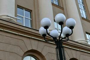 Round decorative street lights on the background of the window. Beautiful street lights in the city. photo