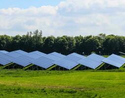 Generating clean energy with solar modules in a big park in northern Europe photo