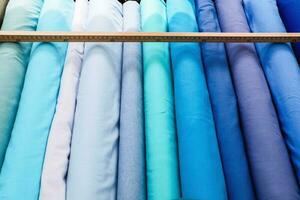 Detailed close up view on samples of cloth and fabrics in different colors found at a fabrics market photo