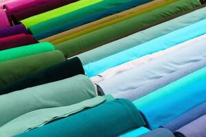 Detailed close up view on samples of cloth and fabrics in different colors found at a fabrics market photo