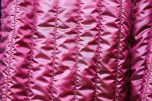 Detailed close up view on samples of cloth and fabrics in different colors found at a fabrics market photo
