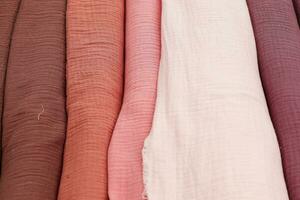 Detailed close up view on samples of cloth and fabrics in different colors found at a fabrics market photo