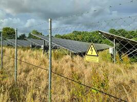 Generating clean energy with solar modules in a big park in northern Europe photo