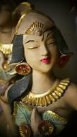 Beautiful artistic statue of a Balinese or javanese dancer used as garden decoration, javanese gnome indonesia photo