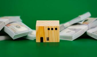 Model wooden house, toy wooden house with dollars, first house, real estate, home loan, home loan, rental house, renting a house financial income, salary, financial investment financial photo