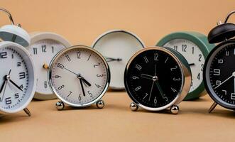 Alarm clock. Beautiful modern clock lies on paper background. time clock time standstill time off work working with time time concept photo