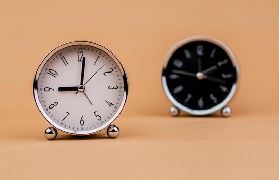 Alarm clock. Beautiful modern clock lies on paper background. time clock time standstill time off work working with time time concept photo