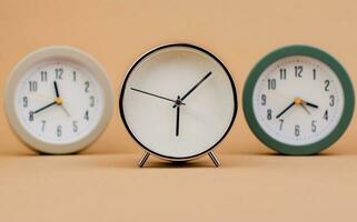 Alarm clock. Beautiful modern clock lies on paper background. time clock time standstill time off work working with time time concept photo