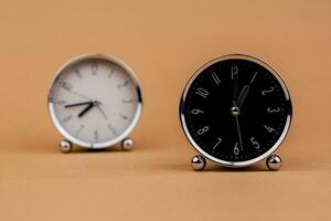 Alarm clock. Beautiful modern clock lies on paper background. time clock time standstill time off work working with time time concept photo