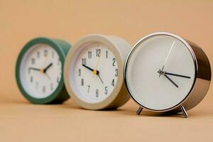 Alarm clock. Beautiful modern clock lies on paper background. time clock time standstill time off work working with time time concept photo