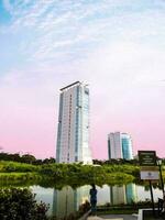 the view of the skyscrapers from the lake side in the evening photo