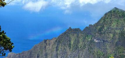 Rainbow in the back drop of a Hawaiian mountain photo