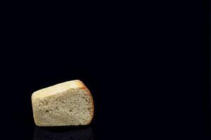 Rye bread on a dark background in the cut with a crispy crust and texture in the hole. Fresh home baked sourdough bread. Photo in high quality