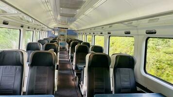 Inside the train. Seats inside the transport. Outside the window is nature . Summer in Ireland. photo