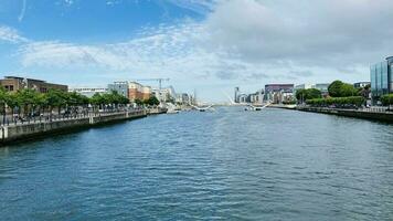 Nice view in Dublin. Nature, buildings by the river. Blue clouds. photo