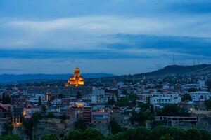 Holy Trinity Cathedral of Tbilisi and Cityscape of Georgia at Twilight photo