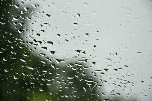 Blurred image of raindrops on the rear view mirror of car, soft focus photo