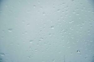 Blurred image of raindrops on the rear view mirror of car, soft focus photo