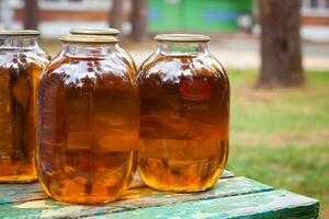 Glass jars with apple juice with iron lids. photo