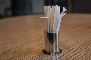 Photo of metal stand with toothpicks on table.