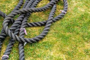 Black rope on green grass for sports. photo