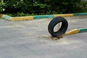 car tire tied with chain Parking place. photo