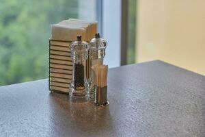 spice toothpick and napkin in holder on table. photo