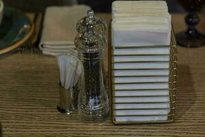 spice toothpick and napkin in holder on table. photo