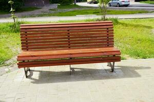 Photo of wooden bench in park on sunny day