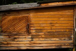 Wooden shed made of slats with a door. photo
