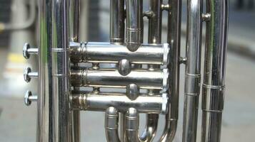 Close up on a valve section of a professional trumpet photo