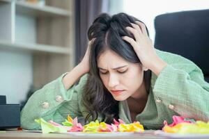 The upset woman with a document in office, Tired emotional, and expressive beautiful woman at a desk photo