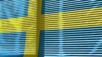 Moving flag of Sweden at wide jalousie window. video