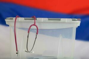 Stethoscope is hanging on the ballot box. Closeup photo